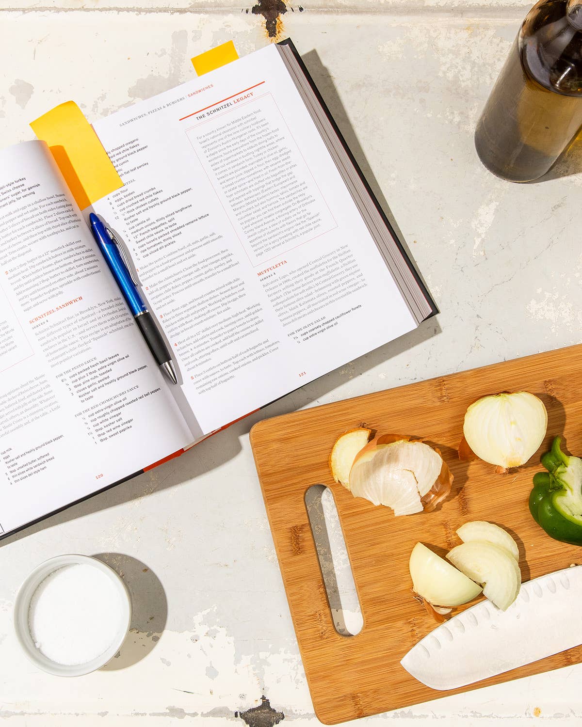 open cookbook with veggies on the cutting board